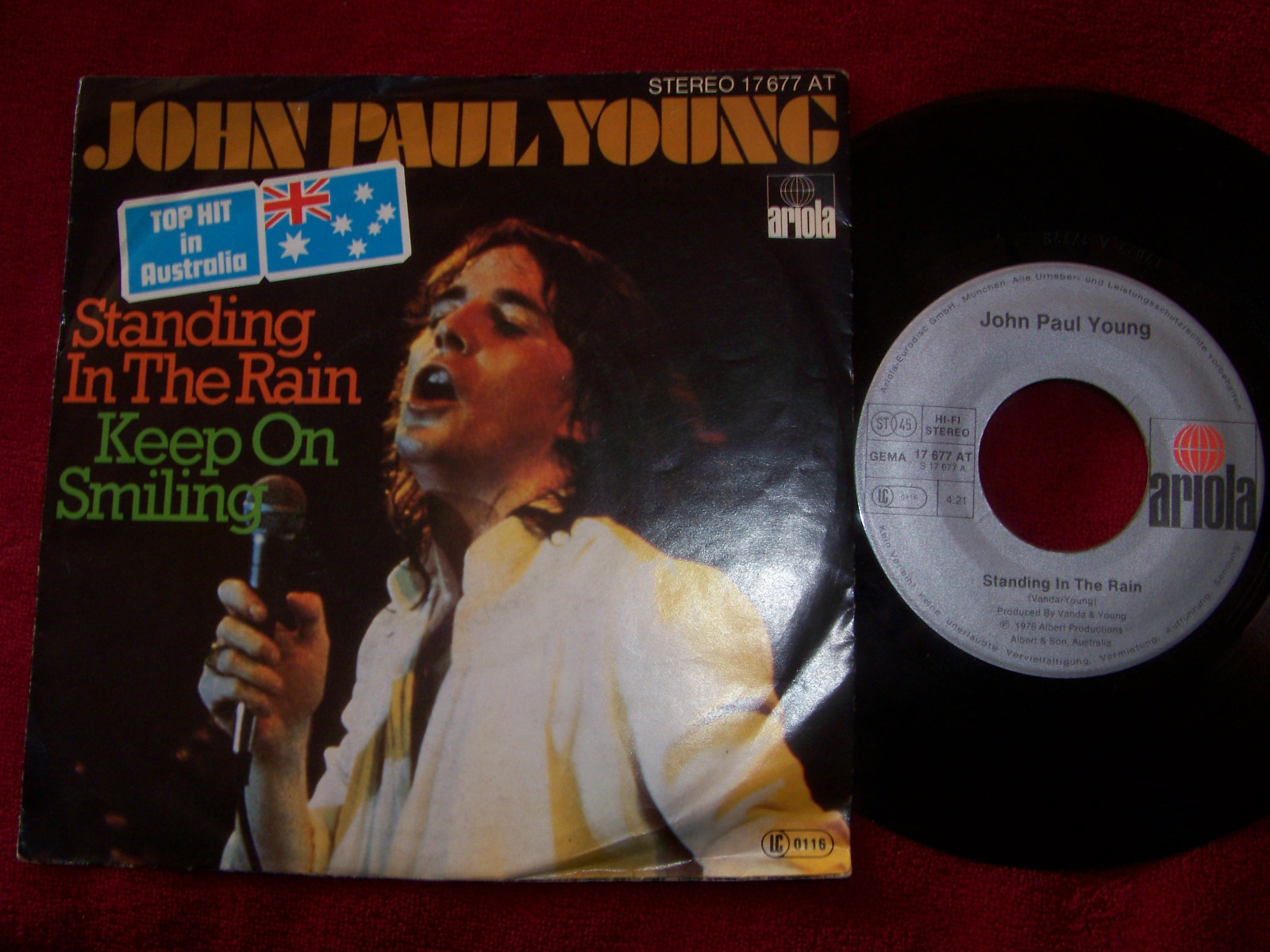 John Paul Young – Standing in the Rain / Keep on Smiling (Ariola, 1976)